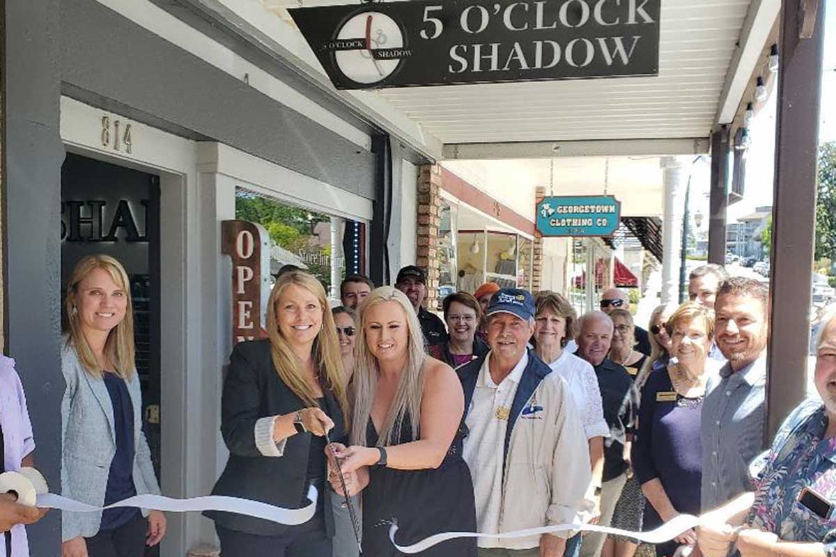 5 O'Clock Shadow owners celebrate the opening of their upscale mens' salon in Downtown Auburn.