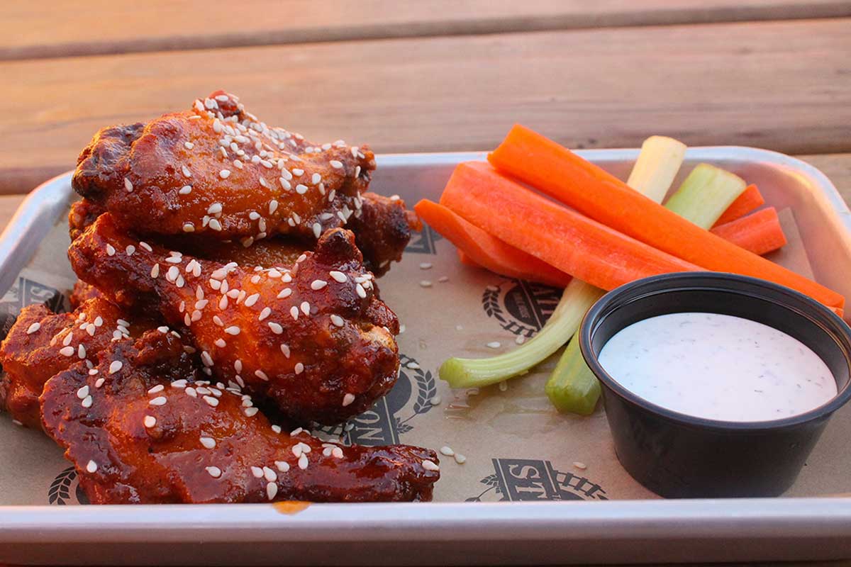 Image of chicken wings in The Station Public House's unique outdoor dining setting.